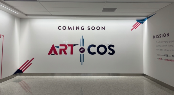 A covered exhibit that reads "Art at COS coming soon"