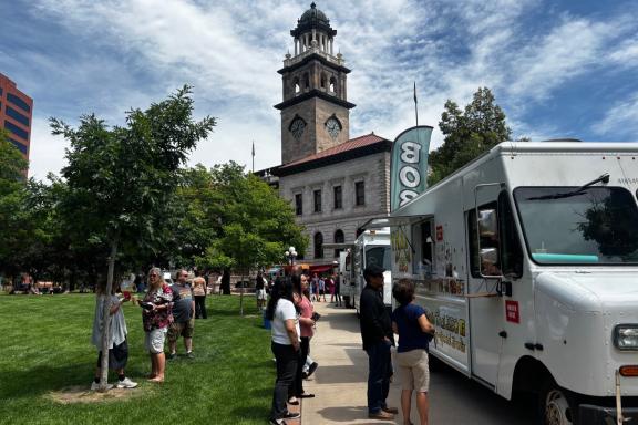 People line up for food trucks outside of the Colorado Springs Pioneer's Museum for Food Truck Tuesday