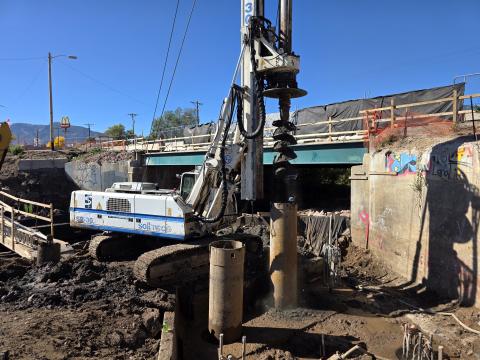An auger slides into a steel sleeve while drilling a new bridge foundation pier on Oct. 8, 2025. The sleeve seals the drill shaft, preventing groundwater and other material from getting into the shaft while crews drill into the bedrock, set rebar in the hole, and pour the concrete to ensure a solid foundation. 
