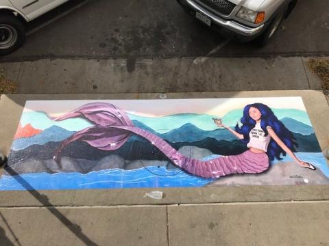 painting of mermaid on storm drain