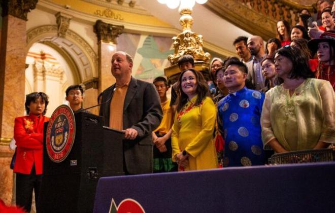 Governor Polis behind a podium on the steps of the Colorado Springs Pioneers Museum, where he signed HB23-1271 into law, making Colorado the second state to officially recognize Lunar New Year as a state holiday. Photo credit Davey Thatcher, Together Creative Media. 