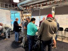 Community members engaging with the community meeting regarding N. Stone Street